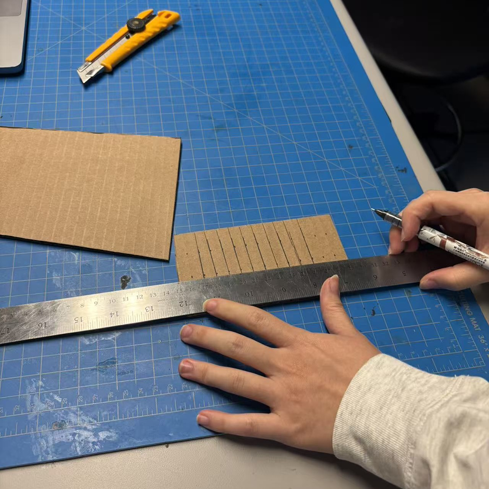 For workshop one, we made a phone stand using cardboard, this process helps us to understand how to make a prototype using cardboard and know what tools can be used to create the prototype. We found a tutorial through YouTube and learned from the video, this photo shows that we were cropping the cardboard.